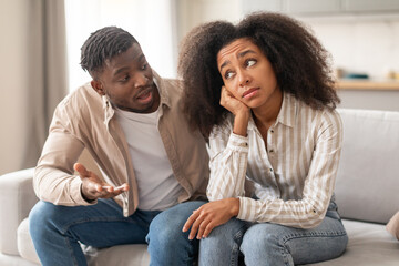 Unhappy millennial black couple arguing facing relationship issues at home