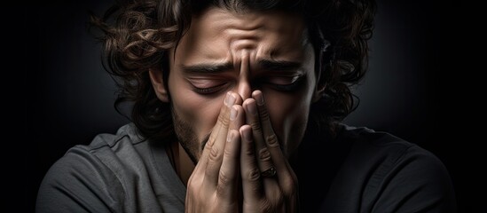 Man Expressing Deep Emotions Through Touching His Face with Clasped Hands - 746058090