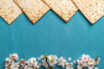 Matzo, decorated with almond flowers. On a blue background. Pesach celebration concept