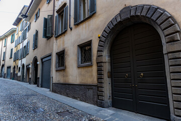 An old building with arched gates in the Italian city of Bergamo