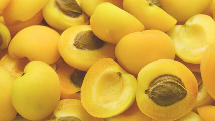 Ripe juicy orange apricots slices fruit background.