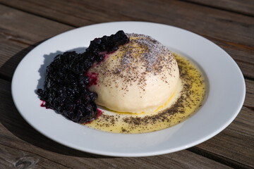 a austrian speciality are sweet dumplings with plum and blueberry jam, melted butter and poppy