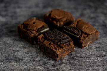 brownie with oreo cookie gray background ready to eat
