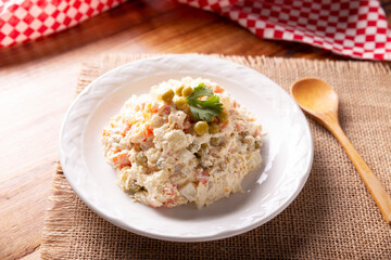 Russian Salad, also known as Olivier Salad. Very popular dish in several countries, the main ingredients are commonly potatoes, mayonnaise and vegetables such as peas, carrots, boiled eggs or chicken
