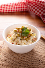 Russian Salad, also known as Olivier Salad. Very popular dish in several countries, the main ingredients are commonly potatoes, mayonnaise and vegetables such as peas, carrots, boiled eggs or chicken