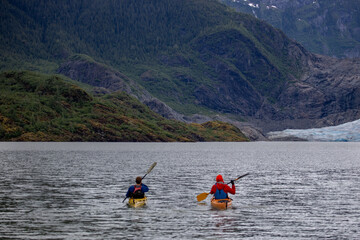 Kayakers paddling across Mendenhall Lake, Juneau, Alaska