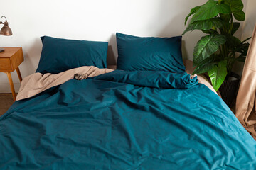 two color washed cotton bed linen in bedroom morning messy