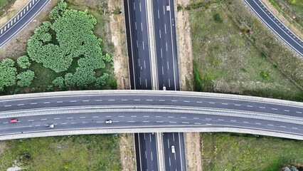 An overhead perspective of a highway featuring two lanes for vehicles to travel. The road stretches into the distance, with cars and trucks moving in different directions.