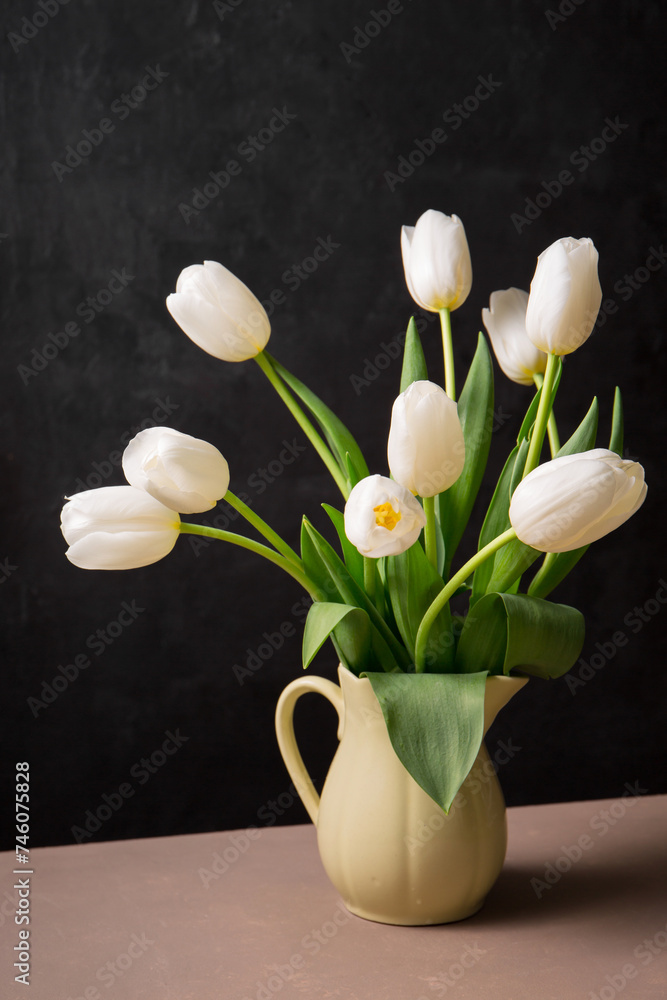 Wall mural A bouquet of white tulips in a yellow jug