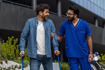 Man with sticks walking with a male nurse