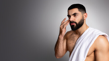 Handsome athletic young arab man with towel on his shoulder