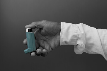 man with respiratory inhaler  puff on grey background with people stock image stock photo   