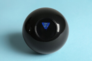 Magic eight ball with prediction Don't Be On It on light blue background