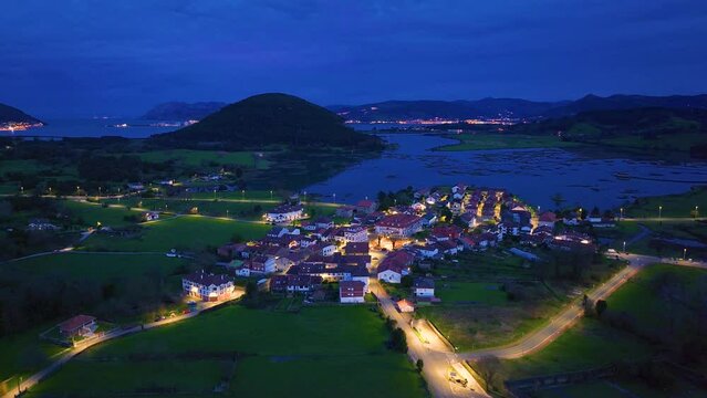 Dusk in the town of Escalante seen from a drone in the Parque Natural de las Marismas de Santo&ntilde;a, Victoria y Joyel Natural Park. Cantabrian Sea. Escalante, Cantabria, Spain, Europe