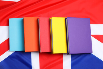 Learning foreign language. Different books on flag of United Kingdom, top view