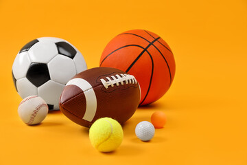Many different sports balls on yellow background, space for text