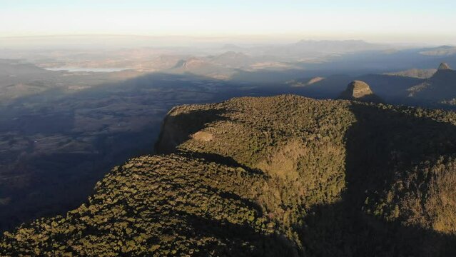 aerial panorama of scenic mountains in main range national park, south east queensland, australia; sunset over bare rock, mount cordeaux, mount mitchell