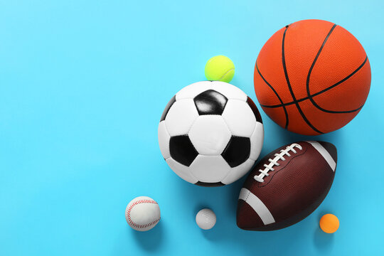 Many different sports balls on light blue background, flat lay. Space for text © New Africa