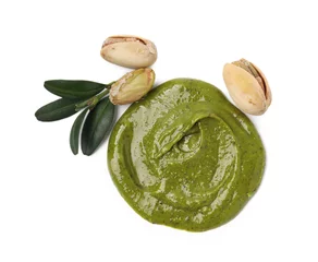 Fotobehang Tasty pistachio cream, green leaves and nuts isolated on white, top view © New Africa