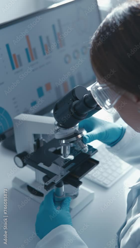 Aufkleber In this vertical video, biologist focuses on analyzing results of an experiment with cells in lab. His research is aimed at elucidating the molecular mechanisms of the development of various diseases.