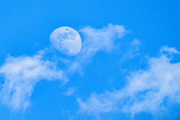 Moon behind the clouds - sharp details on the surface.