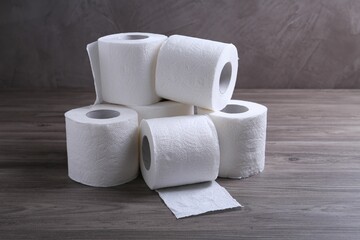 Soft toilet paper rolls on wooden table