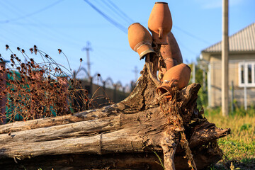 Clay pots on a stump, rural decoration. Background with selective focus and copy space