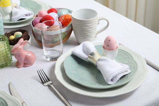 Easter celebration. Festive table setting with painted eggs.