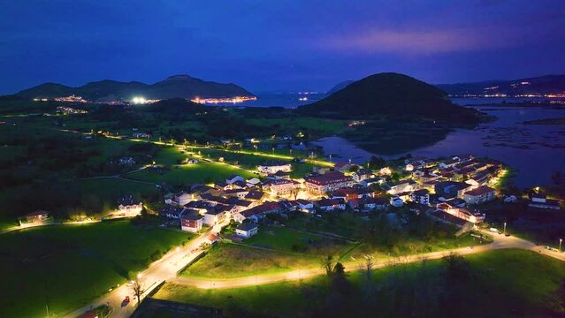 Dusk in the town of Escalante seen from a drone in the Parque Natural de las Marismas de Santo&ntilde;a, Victoria y Joyel Natural Park. Cantabrian Sea. Escalante, Cantabria, Spain, Europe