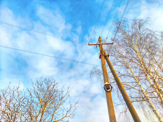 Old pole with wires against the sky. Electric transmission line. Eco-friendly energy