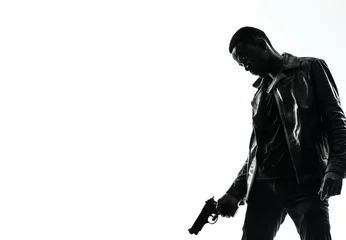 Foto op Aluminium Silhouette of a tough black man holding a gun. Isolated white background with copy space. Private detective. Investigator. Mystery, thriller, action packed pose. Back light. African american man © ana