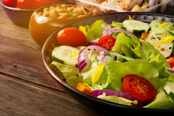 Fresh healthy green salad with tomatoes and vegetables in front view