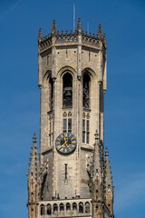 Fototapeta na wymiar Beautiful close-up on the head of the Belfry of Bruges during a sunny day