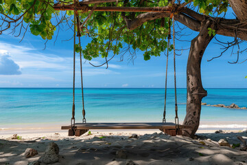 A wooden swing hangs from a leafy tree on a serene tropical beach, inviting a moment of relaxation by the clear blue sea.