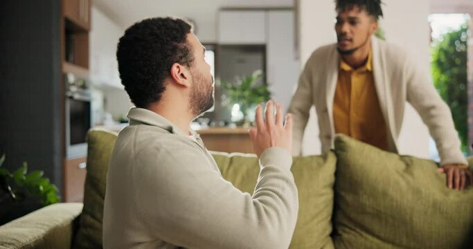 Gay, couple and angry in home with conflict, argument and divorce on sofa for toxic relationship or fail. Lgbtq, people and stress on couch in living room with conversation, jealousy and frustrated