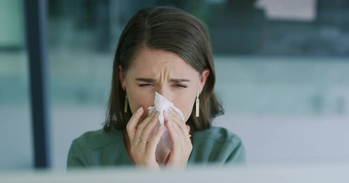 Business woman, sick and blowing nose in office for allergies, virus germs and cold at computer. Face, worker and tissue for infection of influenza, allergy or risk of bacteria, sinusitis or hayfever