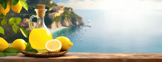 Foto auf Acrylglas Limoncello lemon liqueur in southern Italy on the Amalfi Coast. Transparent jug and citrus fruits. A sunny, aromatic still life. Panorama with copy space. © vidoc