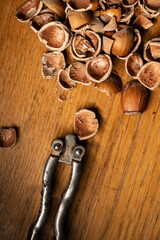 Large pile of hazelnuts with nut cracker.