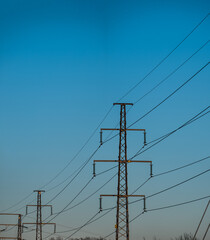 High voltage power lines on evening light.