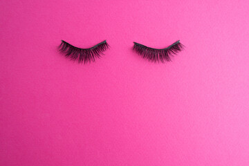 False eyelashes for eye makeup on a colored background. Concept of tool for eyelash extension,...