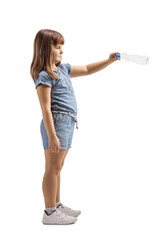 Full length profile shot of a little girl throwing a plastic bottle