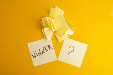 Lottery ticket with the word winner on a colored background near sheets of paper. Winner concept
