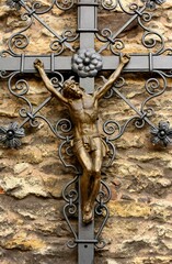 A metal crucifix on a church wall. Catholic symbol