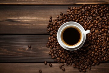 Cup of coffee and coffee beans on a wooden background - Top view