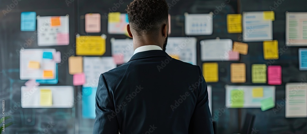 Aufkleber a man is seen standing in front of a wall that is completely covered in colorful sticky notes. the n