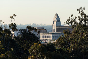 Telephoto view of Los Angeles City Hall with Long Beach harbor cranes on the horizon.  