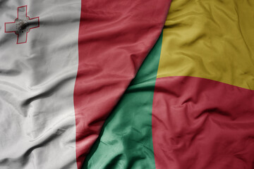 big waving national colorful flag of benin and national flag of malta.