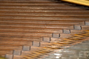 Close up of piano strings inside a grand piano