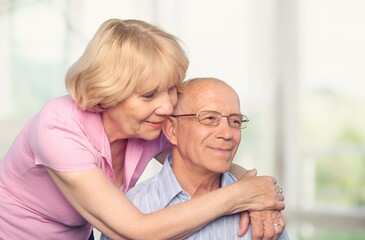 Pensive elderly old man with wife hugging