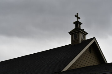 Church steeple against cloudy sky.